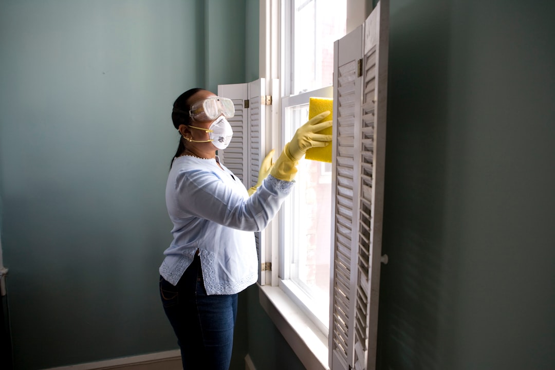services-04 When renovating a home, you should use a damp sponge or cloth to clean dust collected on a window sill, as the dust may contain asbestos or lead-based paint. Home maintenance is an ongoing process for any homeowner, and here we see an African- American woman who’d taken a damp sponge to her window’s frame, in order to remove accumulated dust particulates. Note how the homeowner had donned a pair of waterproof gloves, a facemask, and a pair of goggles, prior to beginning this task.