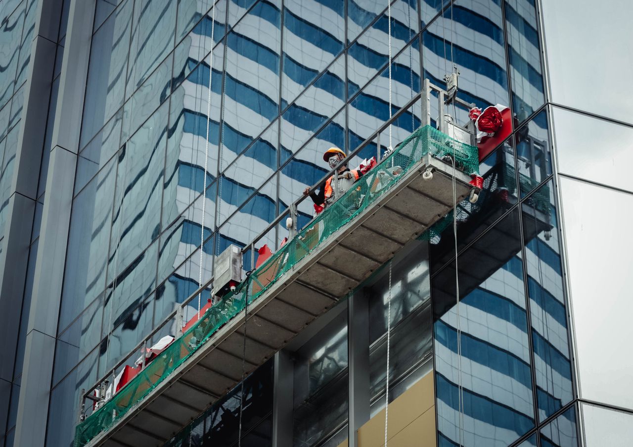 about-01 Urban worker cleaning windows on a high-rise in Ho Chi Minh City, Vietnam.